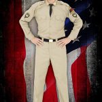 Elvis impersonator JD King in GI uniform in front of US flag